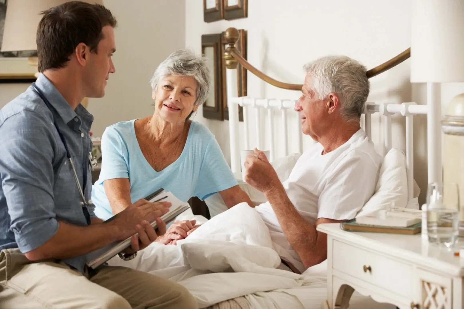Doctor consulting elderly couple at home