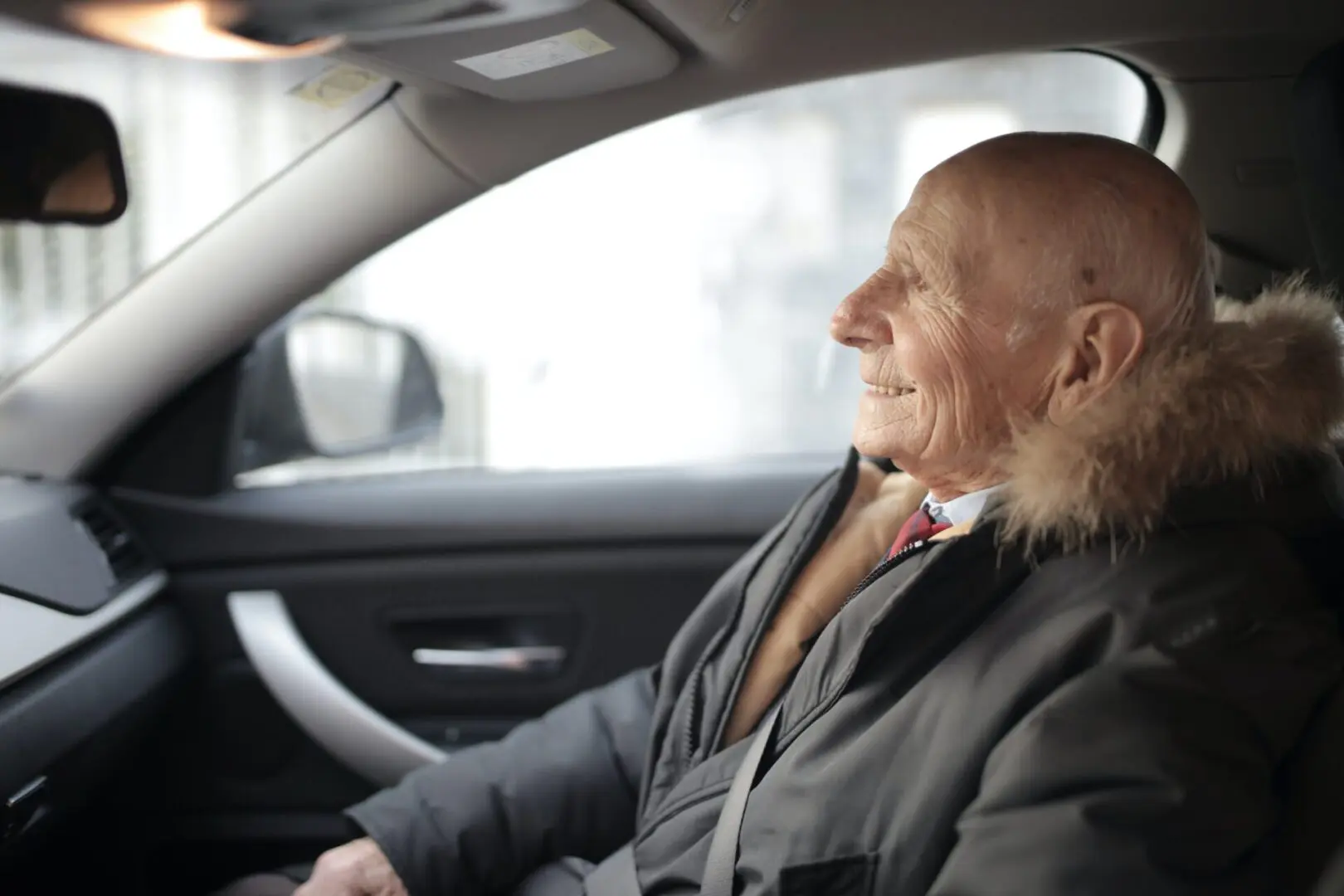 Happy older man in vehicle