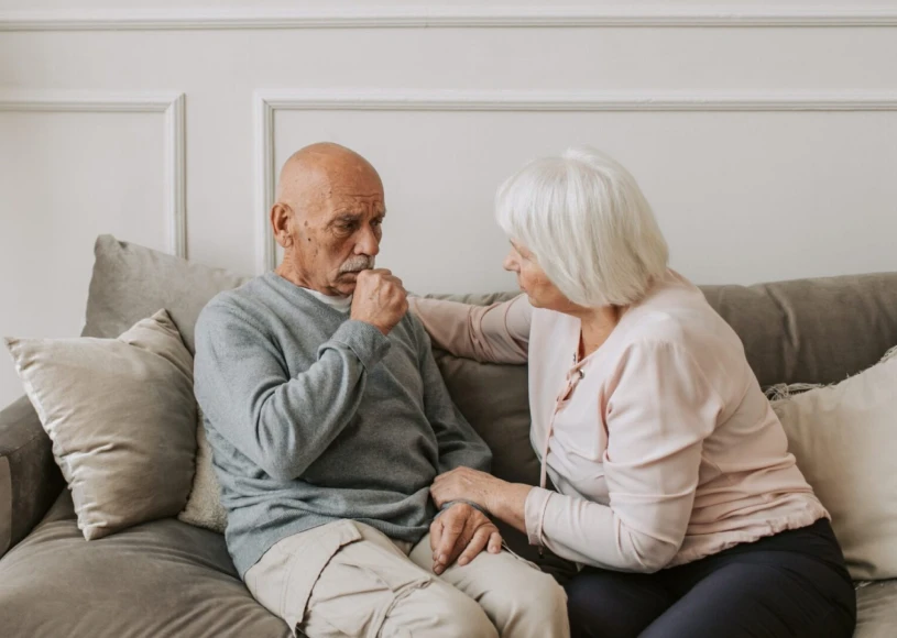 Caring elderly couple on a sofa