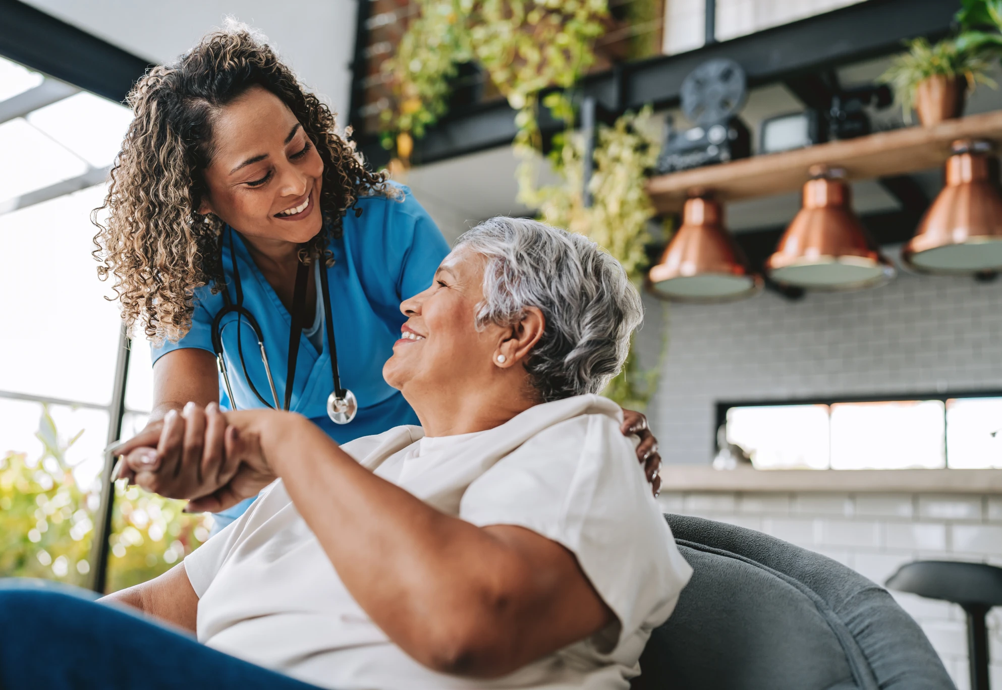 Healthcare worker and elderly woman interacting