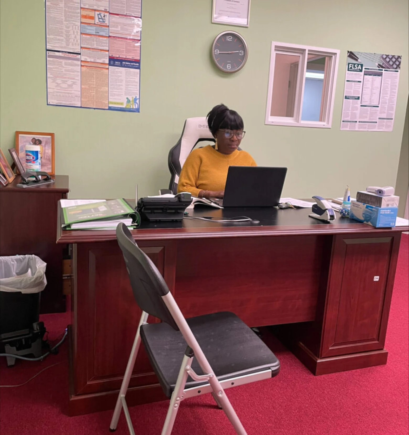 Woman working at office desk with laptop