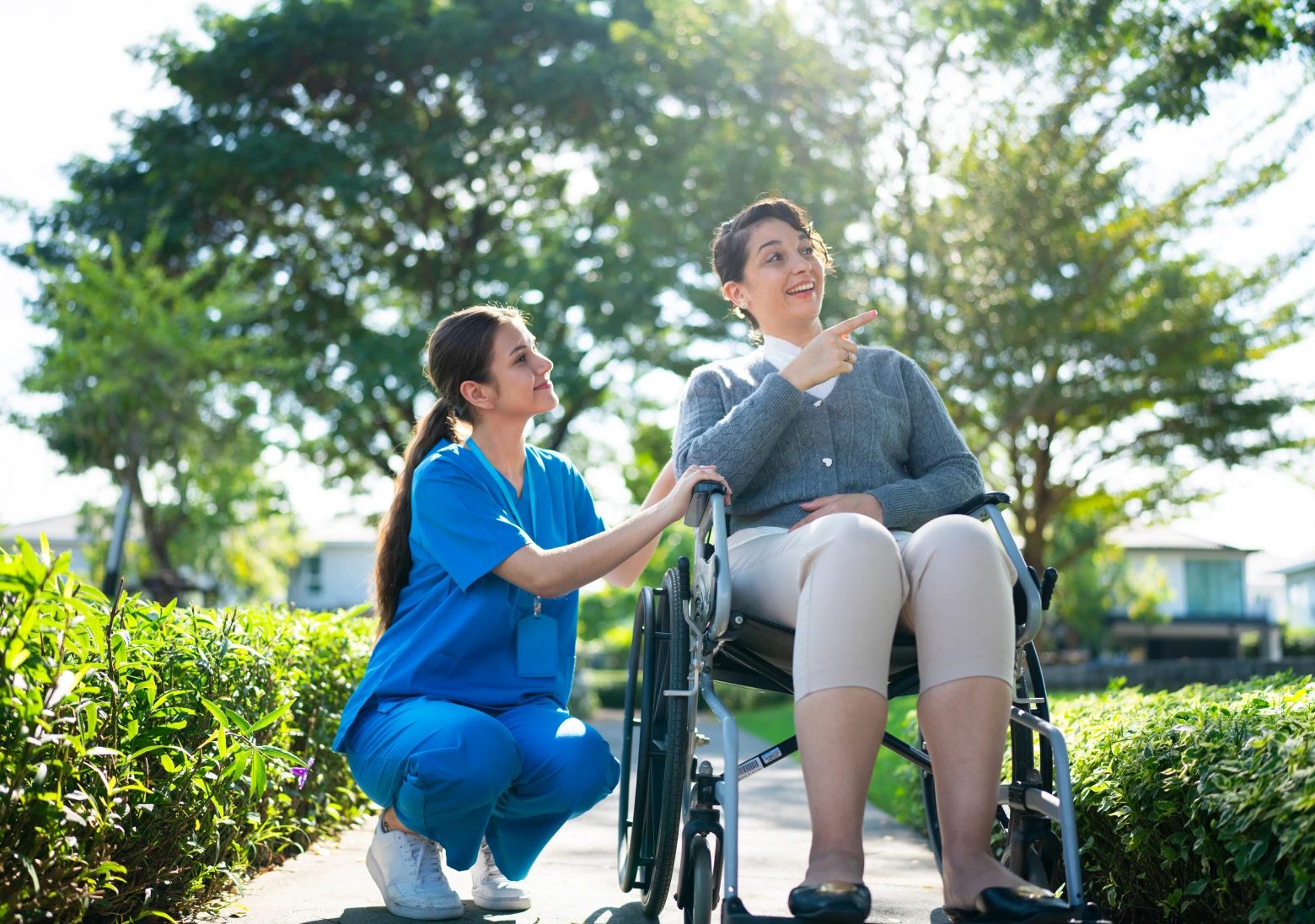 Outdoor stroll with caregiver and wheelchair user