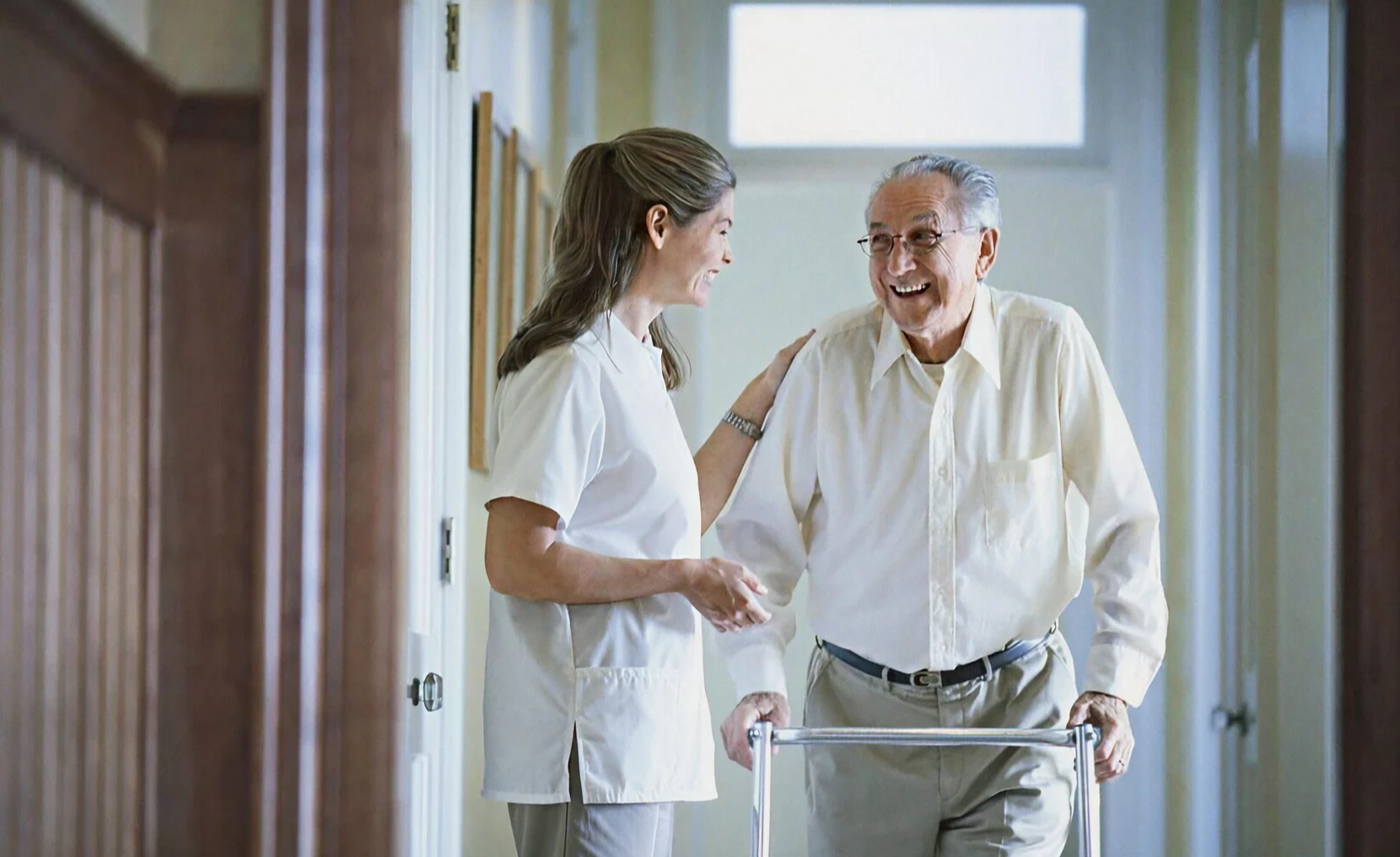 Caregiver smiling with senior patient