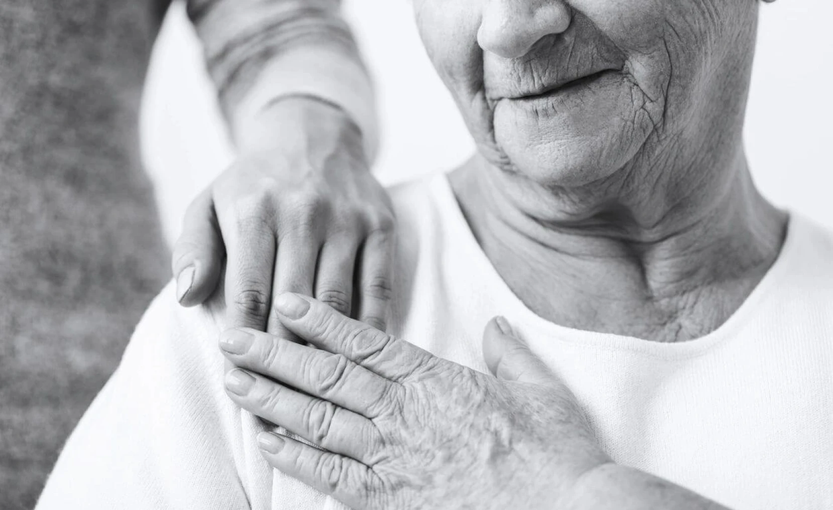 Elderly woman comforted by a gentle touch