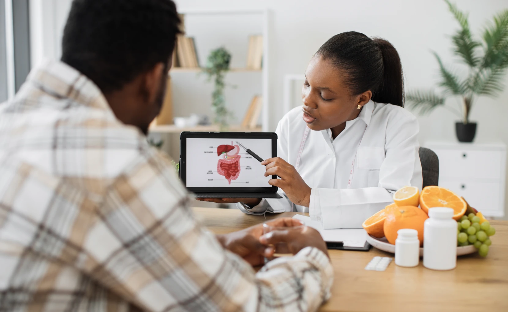 Medical consultation with tablet diagram